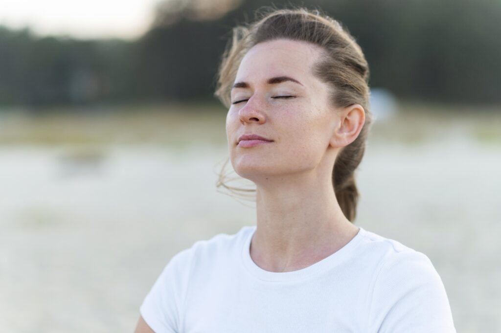 woman-taking-fresh-ocean-breeze-beach-workout